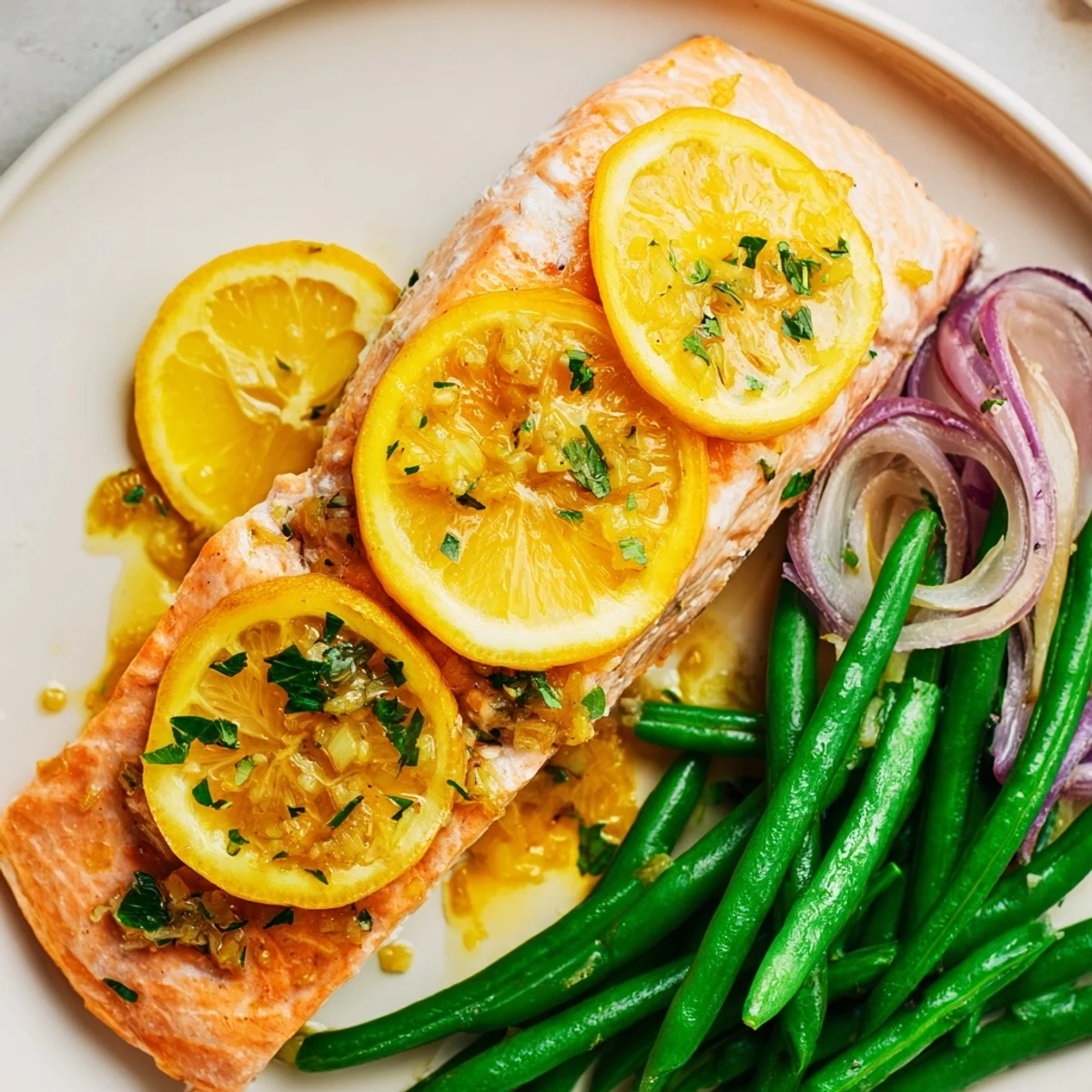 Roasted Sheet Pan Salmon and Green Beans with Lemon Butter served alongside fluffy white rice on a rustic dinner table.