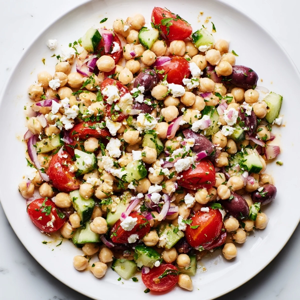 Freshly prepared Mediterranean Chickpea Salad with feta and olives, ready to serve as a vibrant side dish or light vegetarian lunch.
