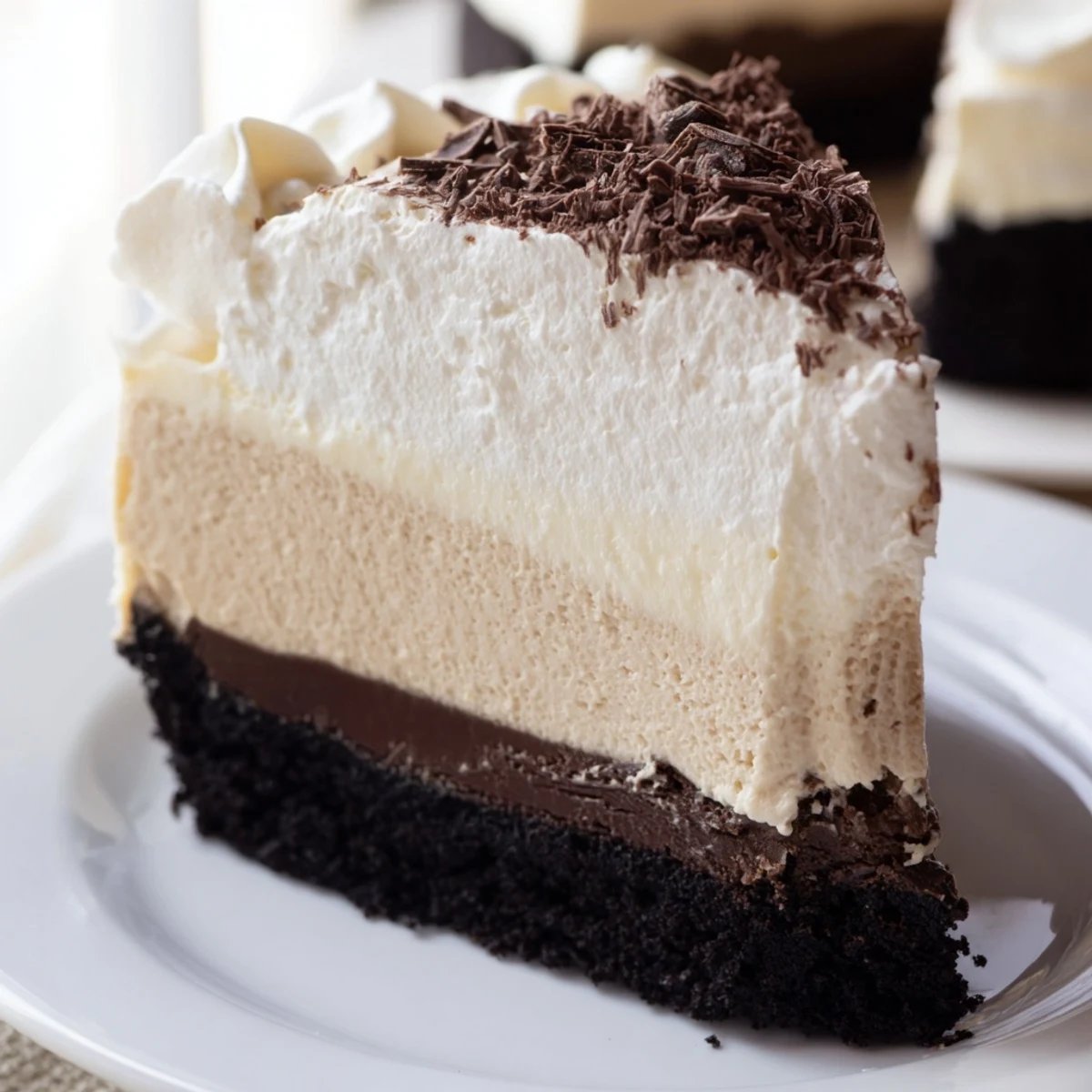 A Bailey Style Irish Cream Cheesecake whole, perfectly set with a chocolate cookie crust and garnished with grated chocolate.  