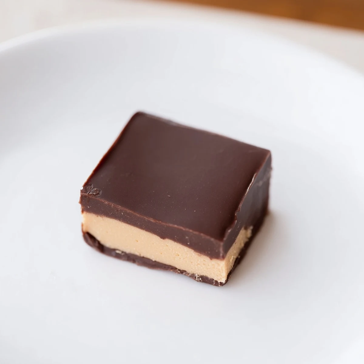 Homemade Chocolate Peanut Butter Fudge Squares arranged neatly on a marble countertop, ready to serve.