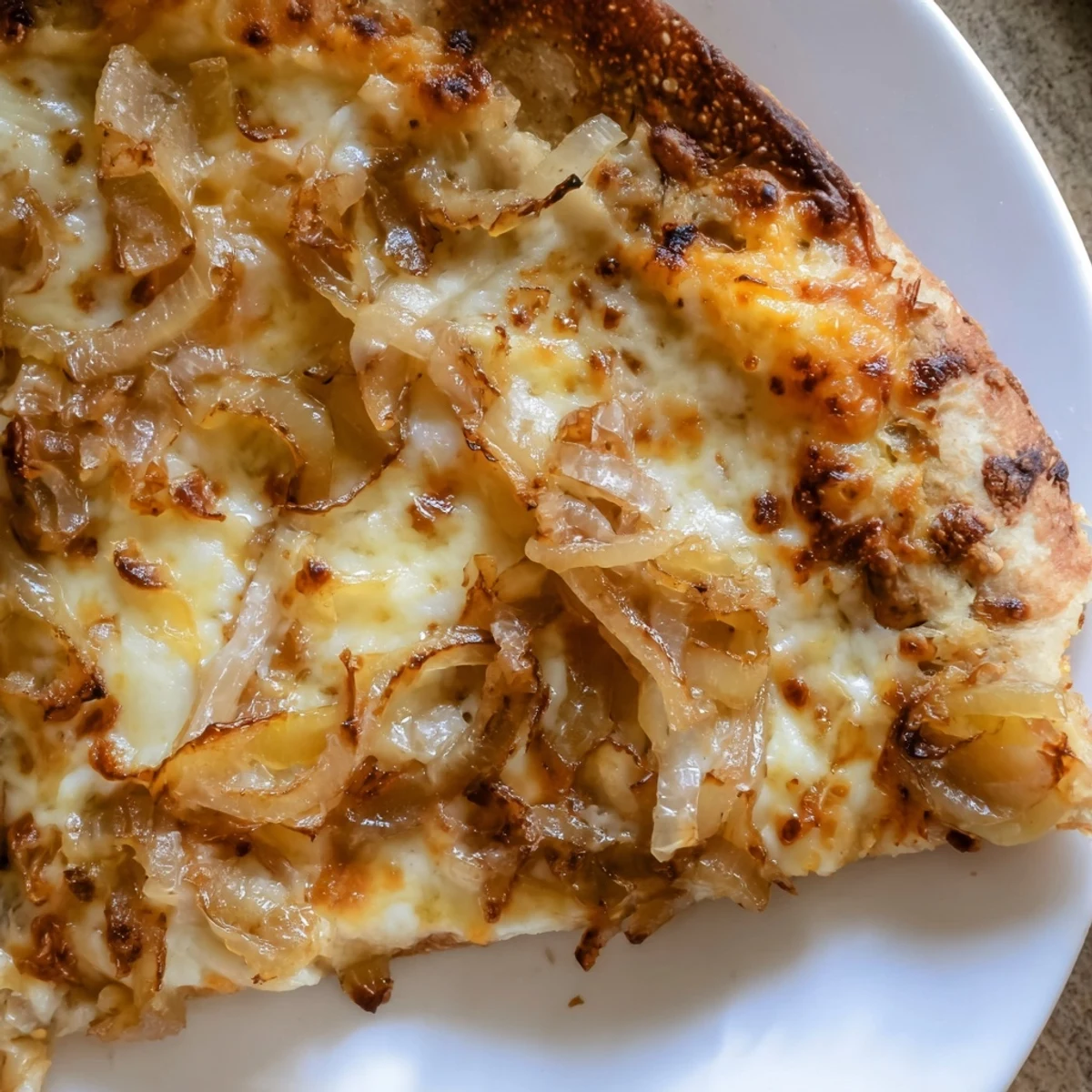 Freshly baked Caramelized Onion Pizza With Melty Cheese features golden crust with bubbling cheese and sweet onions.