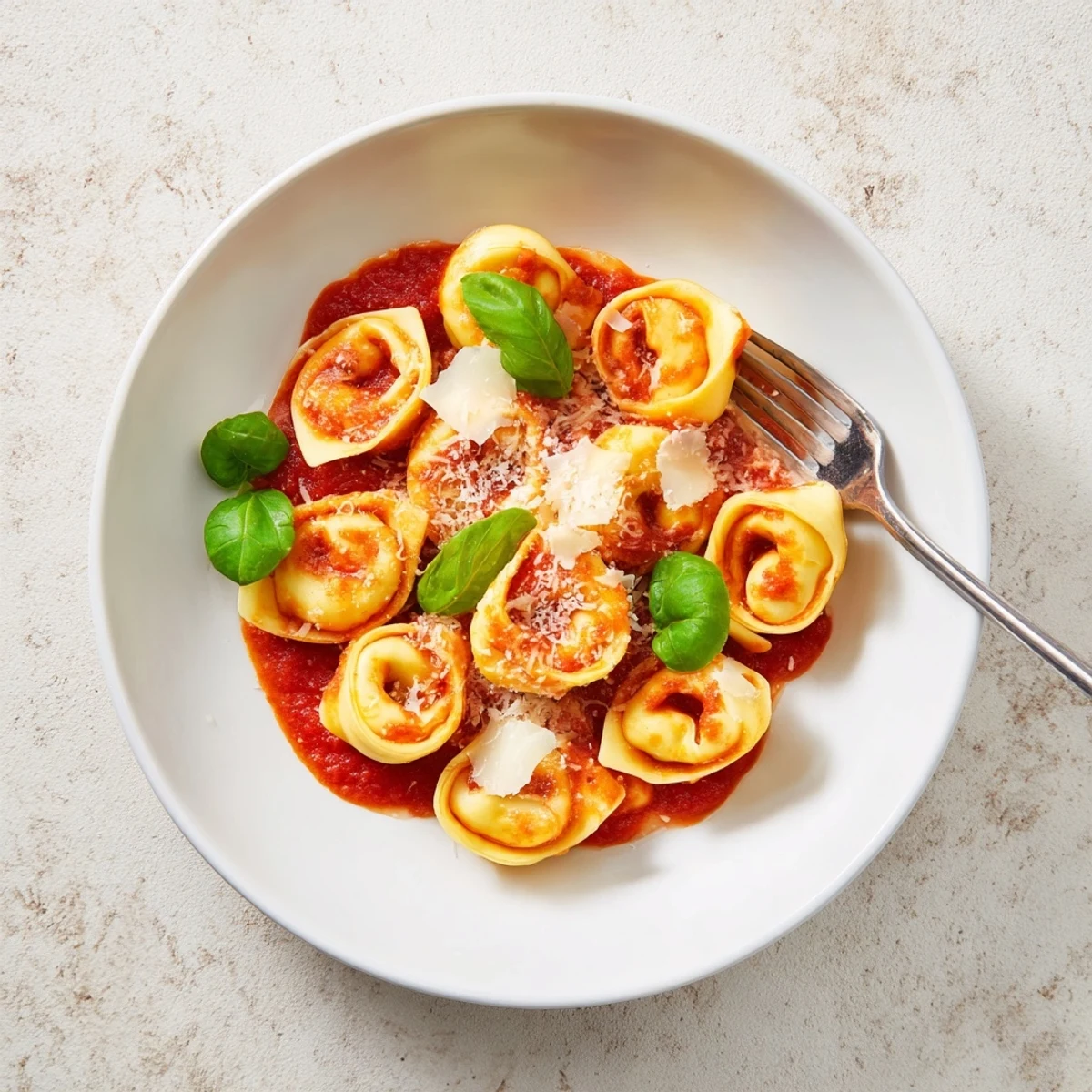 A close-up of tender Mozzarella Tortellini tossed in garlicky tomato sauce, ready for a comforting weeknight Italian dinner.  