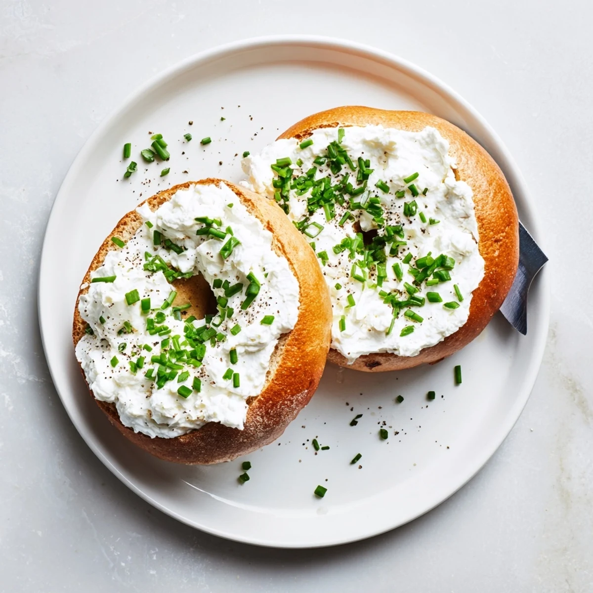 Golden-brown Protein Bagels with Cottage Cheese served warm with extra cottage cheese and black pepper garnish.