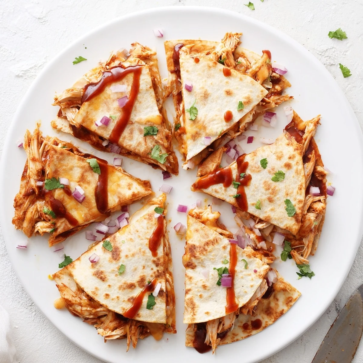 Golden tortillas stuffed with smoky hot honey BBQ chicken and melty cheese, served warm with lime wedges.