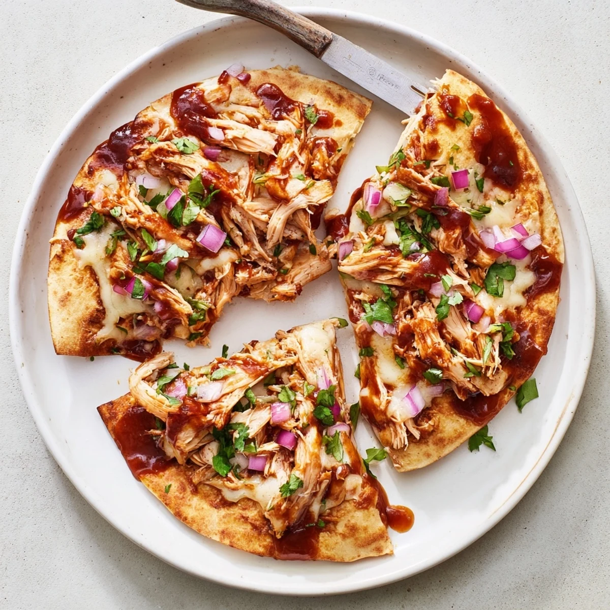 A close-up of crispy hot honey BBQ chicken quesadillas sliced to reveal juicy filling and melted cheese.