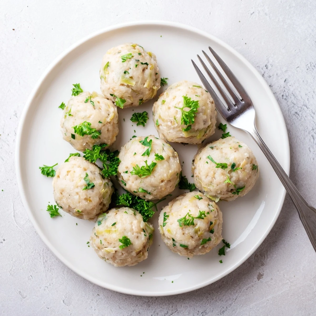 Steamed German Cabbage Dumplings are light and fluffy, filled with savory cabbage and herbs, served as a comforting vegetarian main or side dish.