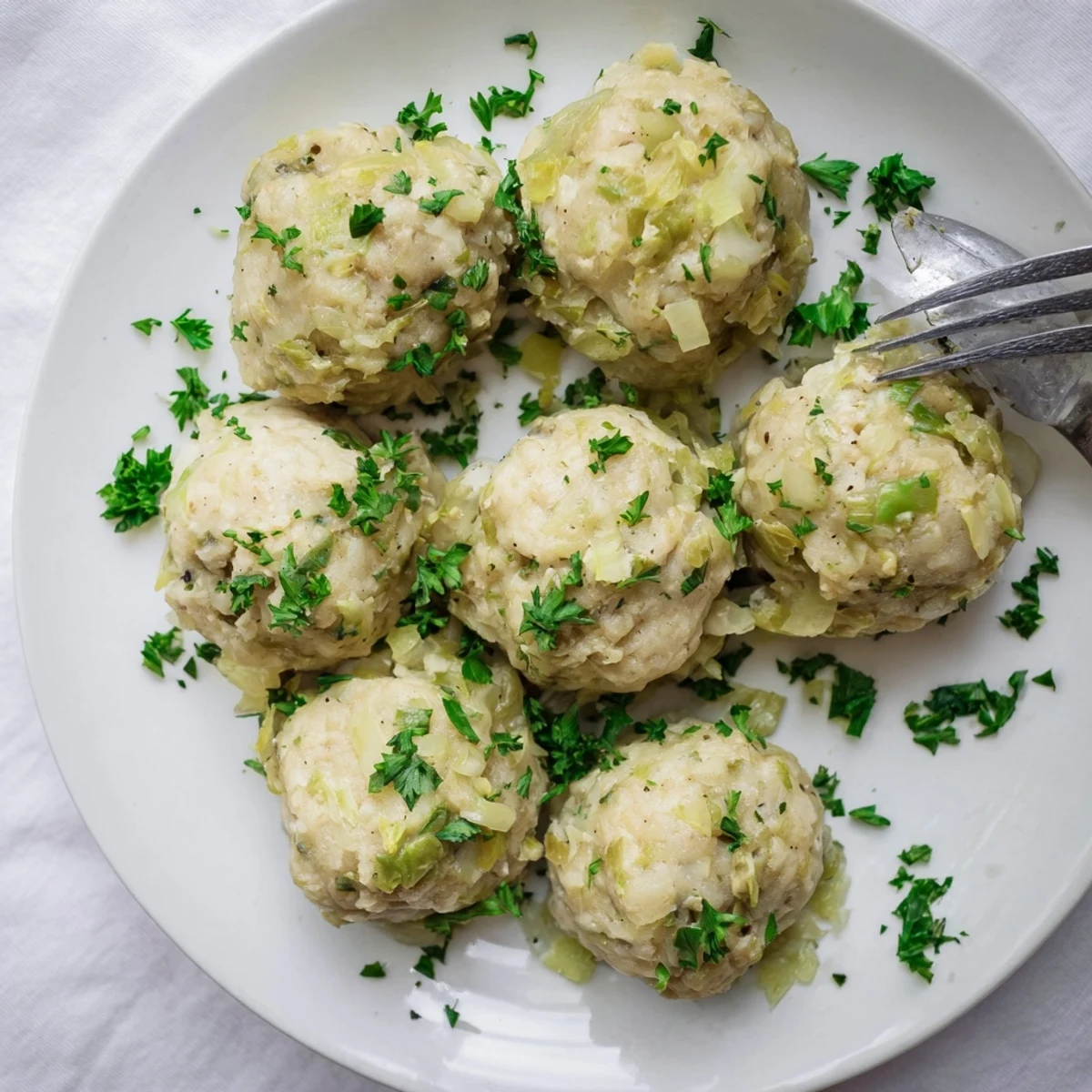 German Cabbage Dumplings simmered in vegetable broth, tender and aromatic, displaying a light golden texture ideal for a classic German family dinner.