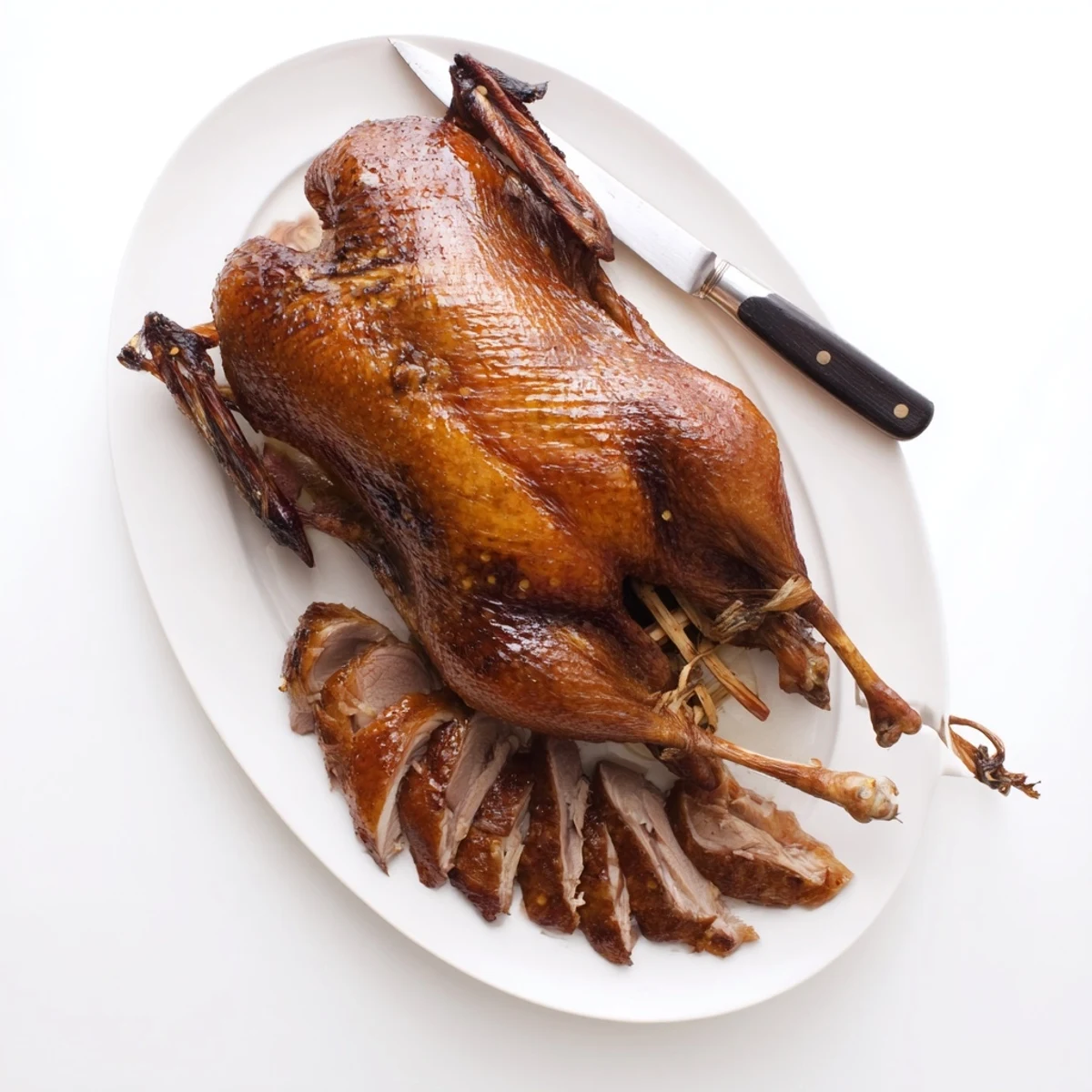 Festive whole roast duck seasoned with aromatic five spice powder and fresh orange garnish