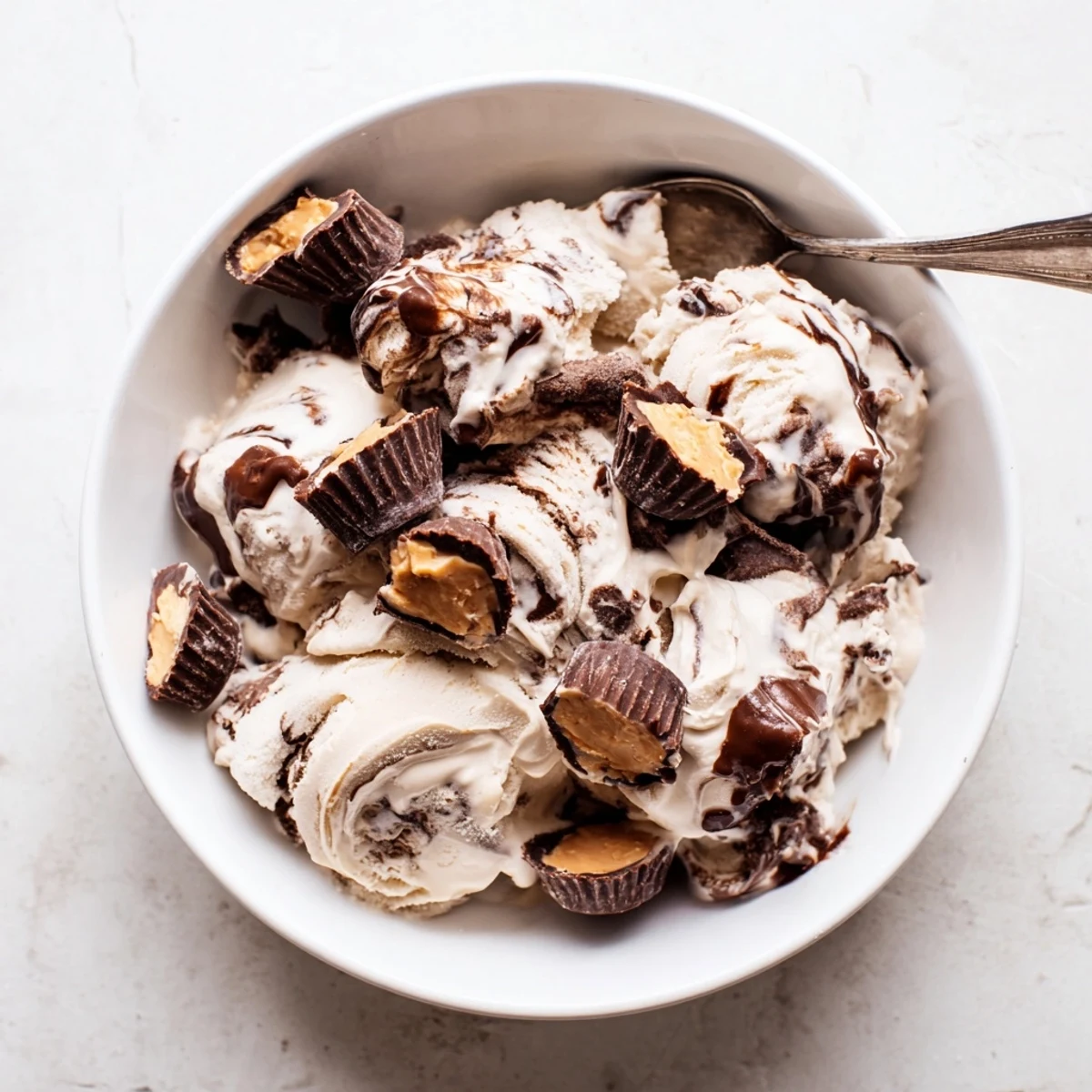 Creamy homemade Moose Tracks ice cream with fudge swirls and peanut butter cup chunks