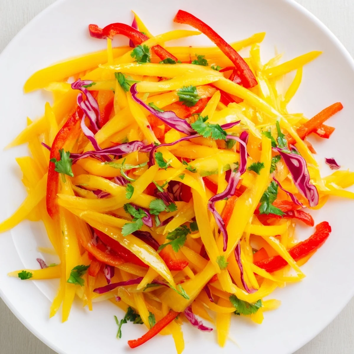 Vibrant mango slaw with crisp red cabbage and carrots in tangy lime dressing