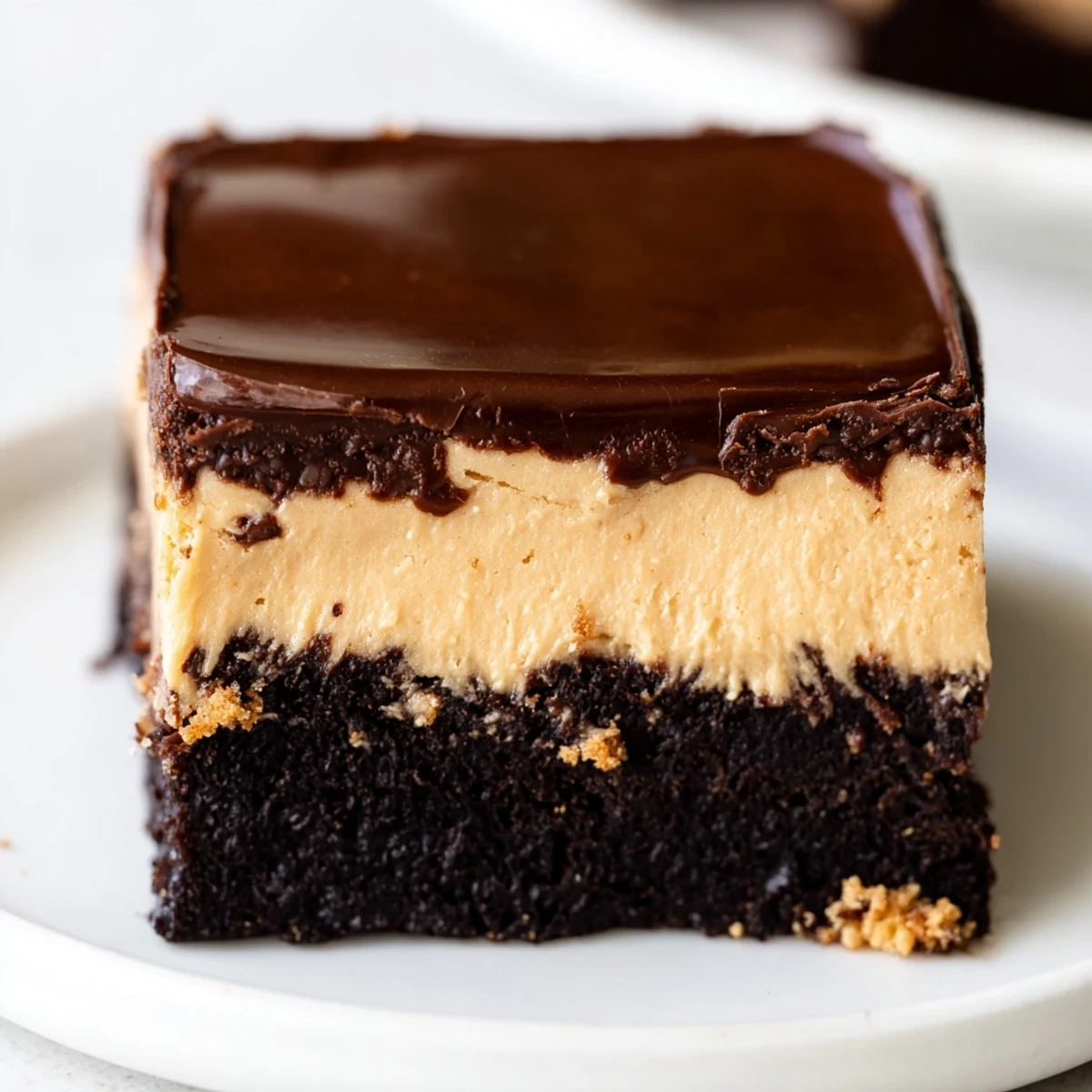 Rich layered peanut butter brownies showcasing fudgy chocolate base and creamy peanut butter topping
