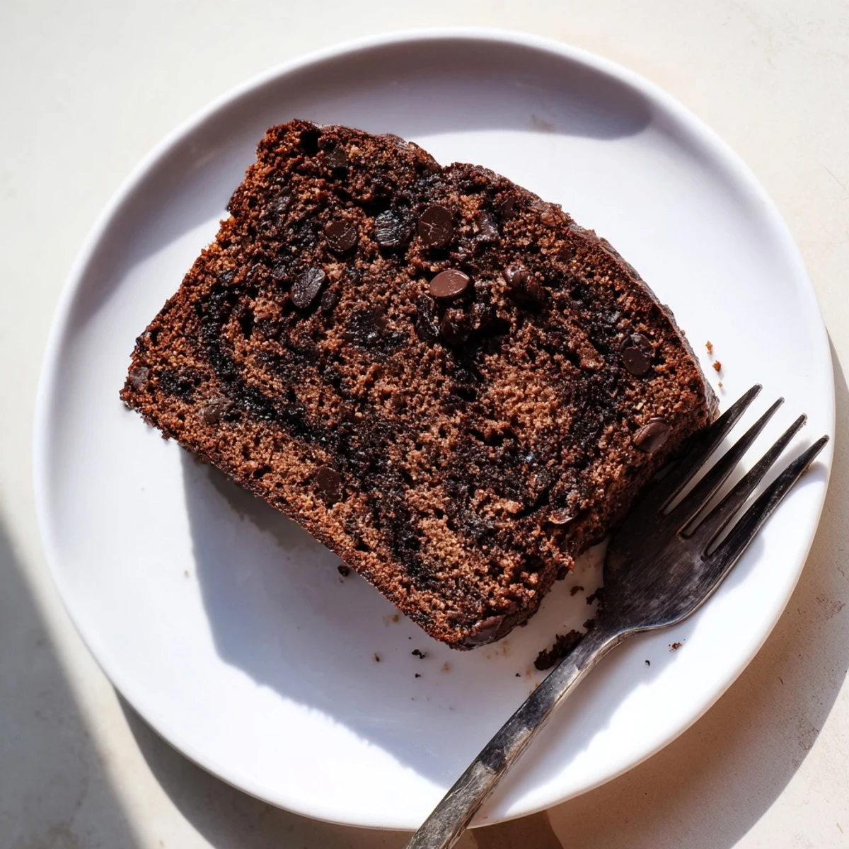 Rich dark chocolate espresso banana bread served warm with butter and a steaming cup of coffee