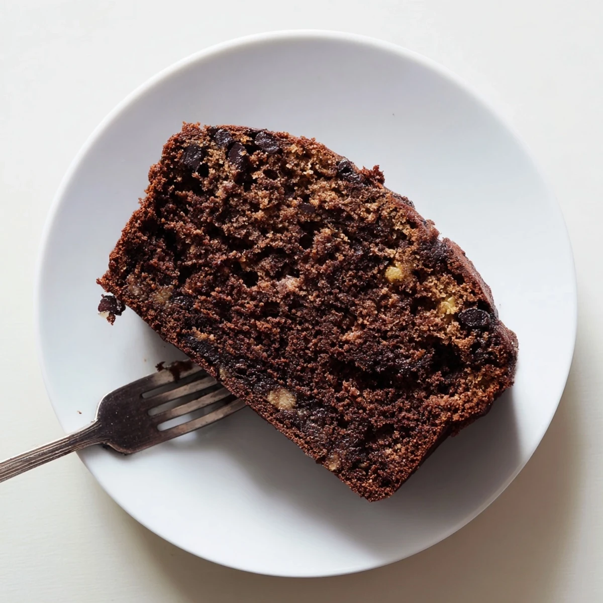 Freshly baked chocolate espresso banana bread with golden crust displaying tender chocolate-studded crumb texture