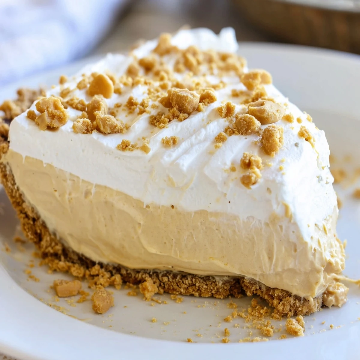 Amish Peanut Butter Dream Pie slice revealing velvety vanilla pudding filling in flaky golden crust