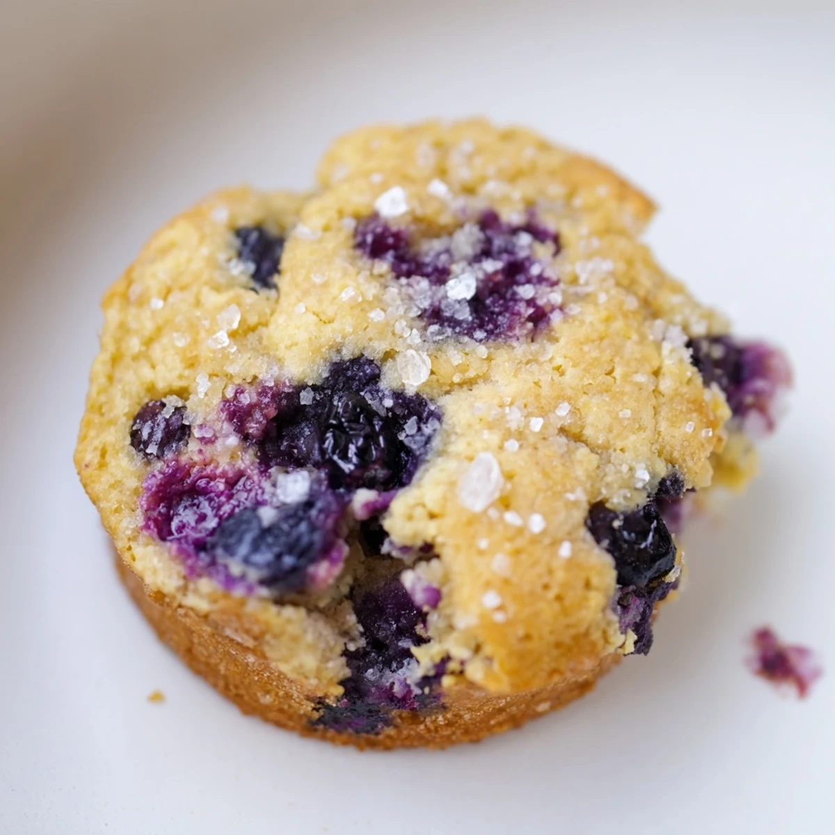 Soft blueberry muffin cookies with golden edges and juicy berries on a rustic baking sheet