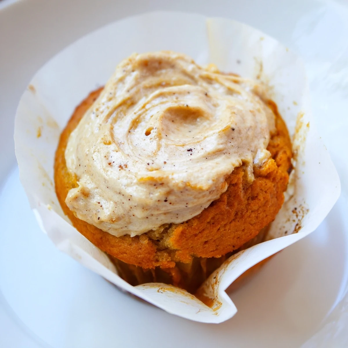 Golden chai pumpkin cheesecake muffins with a creamy swirled topping fresh from the oven