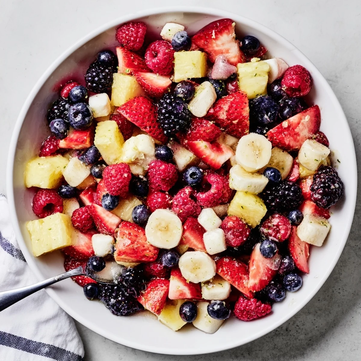 Chilled Red White And Blue Fruit Salad with honey lime dressing and mint