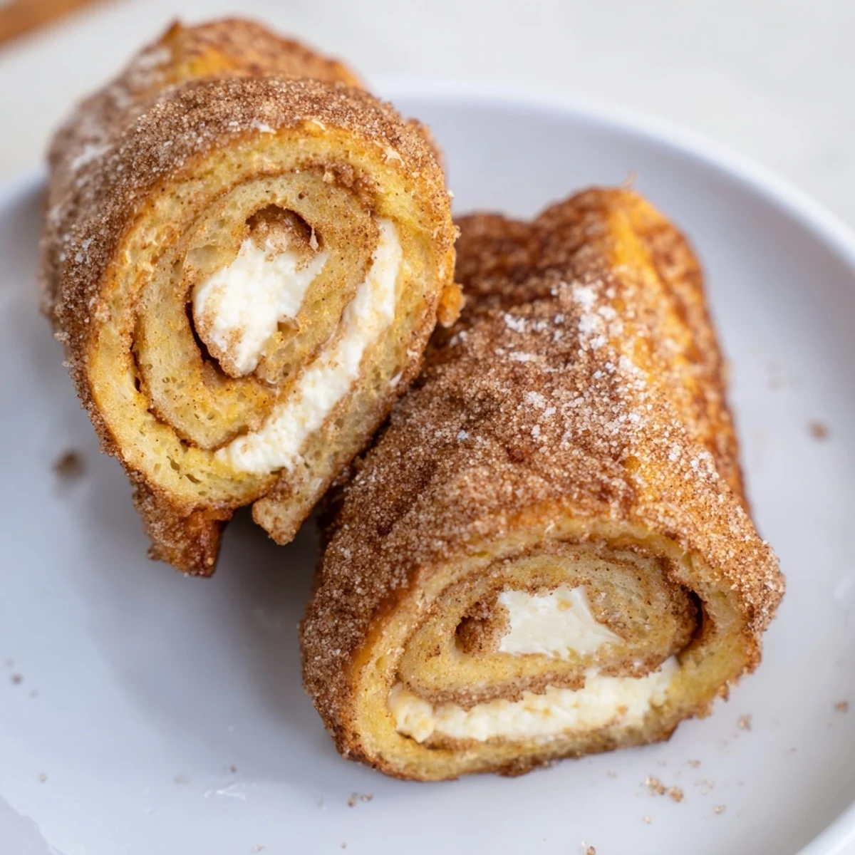 Cinnamon Roll French Toast Roll Ups with cream cheese centers and cinnamon sugar crust