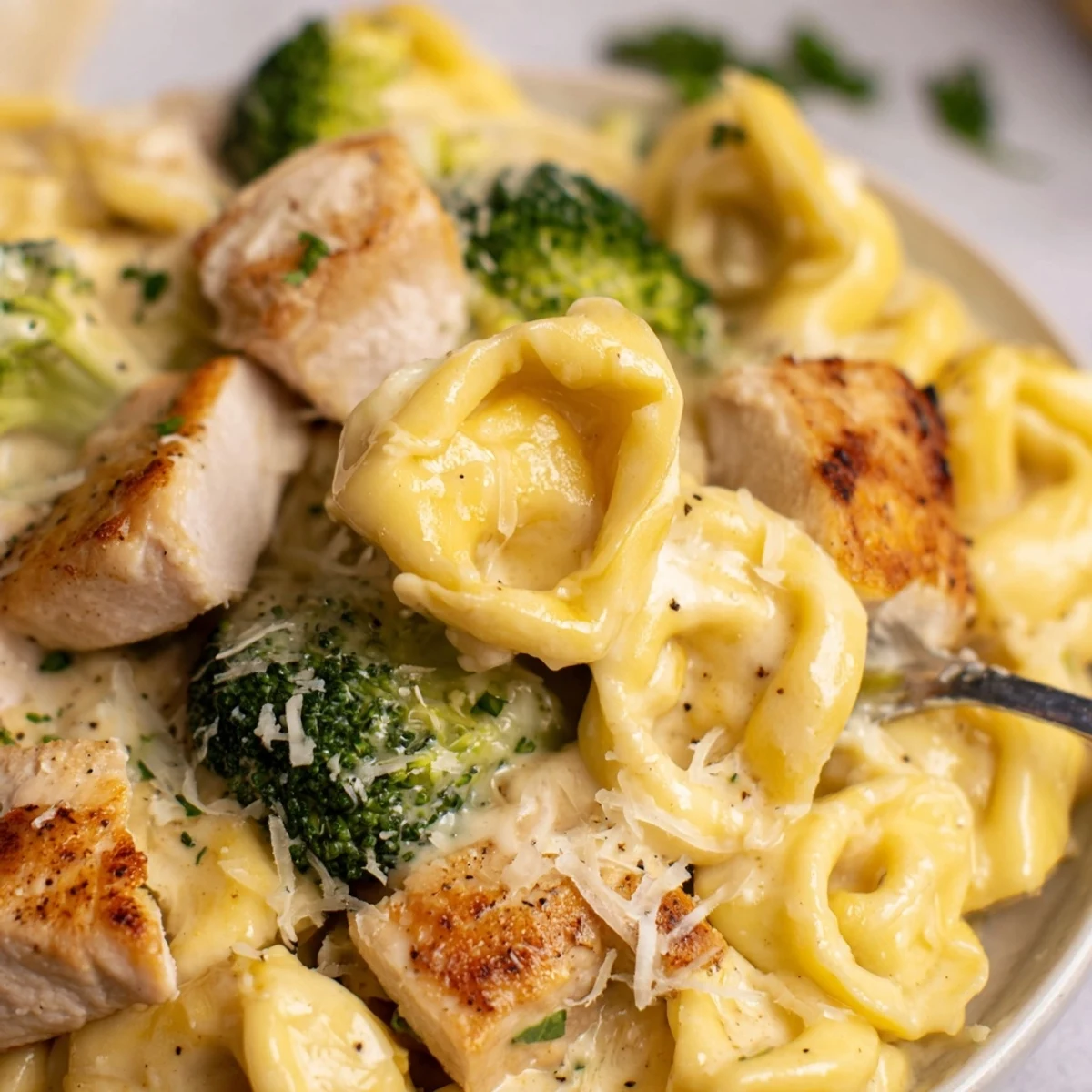 Creamy Garlic Parmesan Tortellini Chicken Broccoli Recipe steaming in skillet, rich garlic aroma