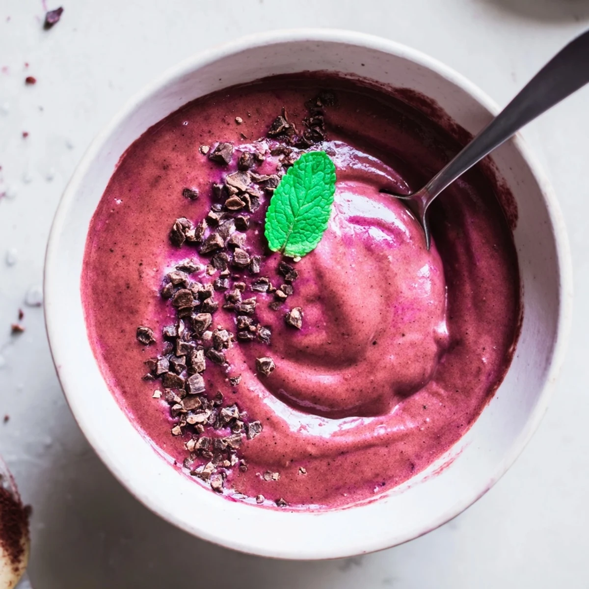 Frosty Chocolate Beet Smoothie topped with cacao nibs and fresh mint
