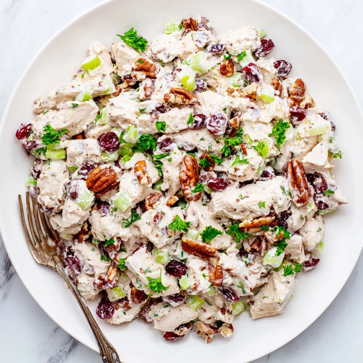 Toasted pecans and dried cranberries mixed into tender chicken salad with mayo