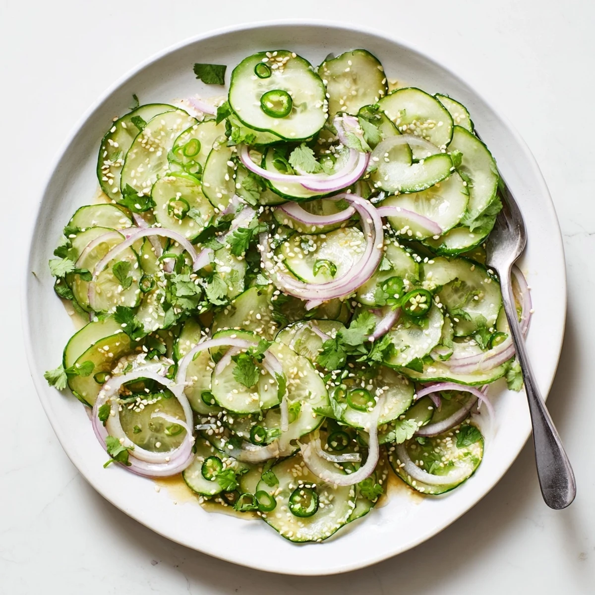 Fresh honey lime cucumber salad with crisp sliced cucumbers in a tangy citrus dressing