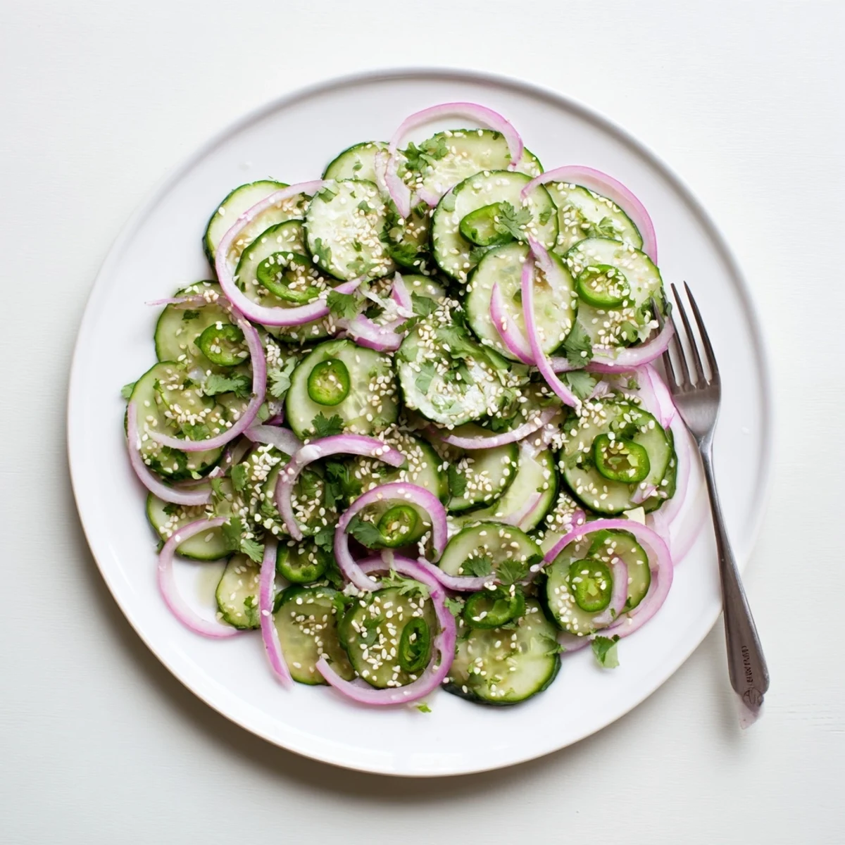 Close-up of refreshing honey lime cucumber salad featuring thinly sliced cucumbers coated in sweet lime dressing