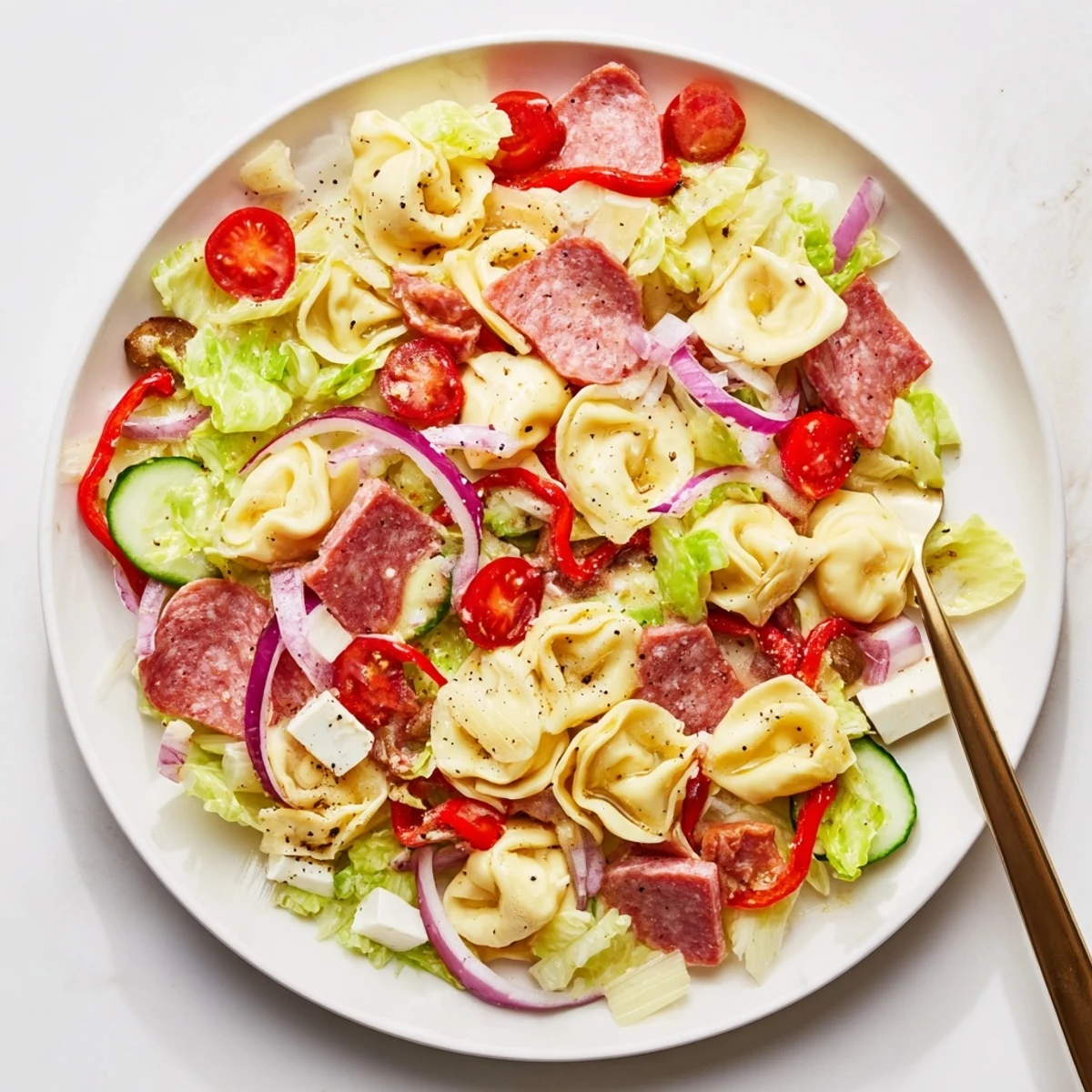 Vibrant tortellini salad recipe with cherry tomatoes, peppers, and savory grinder flavors tossed in olive oil dressing