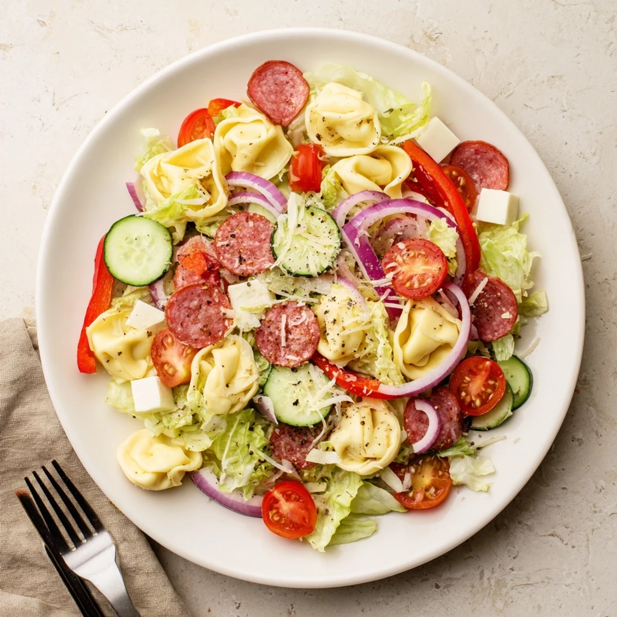 Hearty Italian-inspired grinder tortellini salad recipe featuring crisp veggies, provolone, and tangy homemade vinaigrette