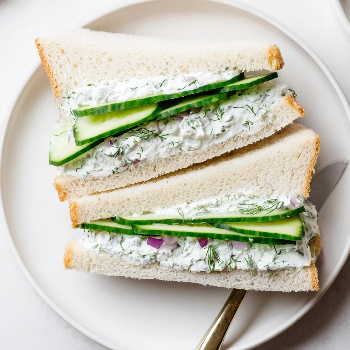 Refreshing cucumber salad sandwiches featuring crisp cucumber slices and tangy cream cheese filling