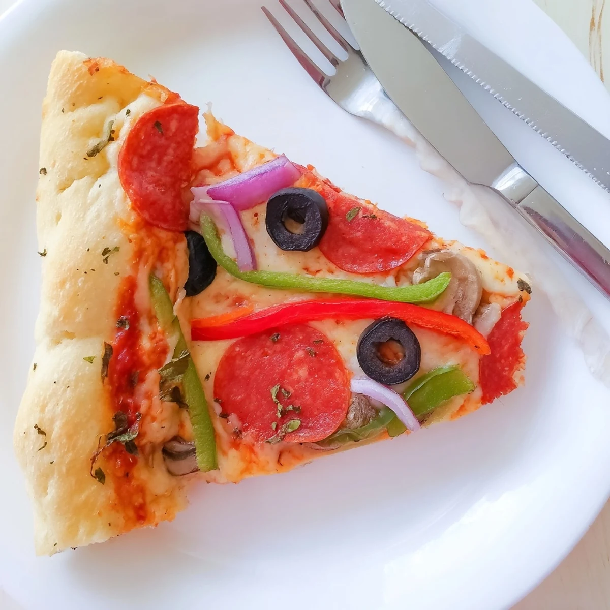 Hearty Focaccia Pizza Supreme topped with peppers, olives, melted golden cheese