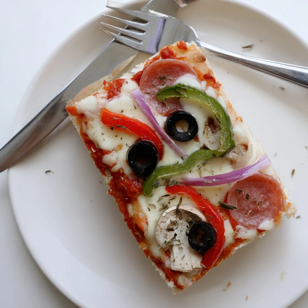 Sliced Focaccia Pizza Supreme on sheet pan, olive oil sheen, steaming  