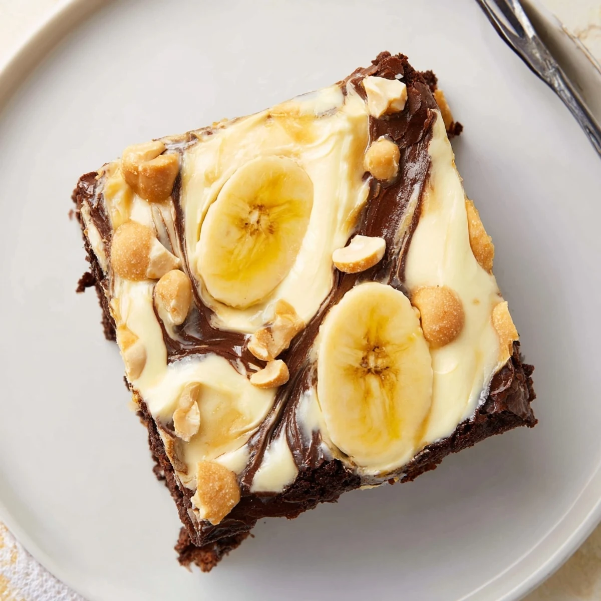 Warm Banana Pudding Brownies cooling in pan, fudgy center and vanilla wafer crumbs