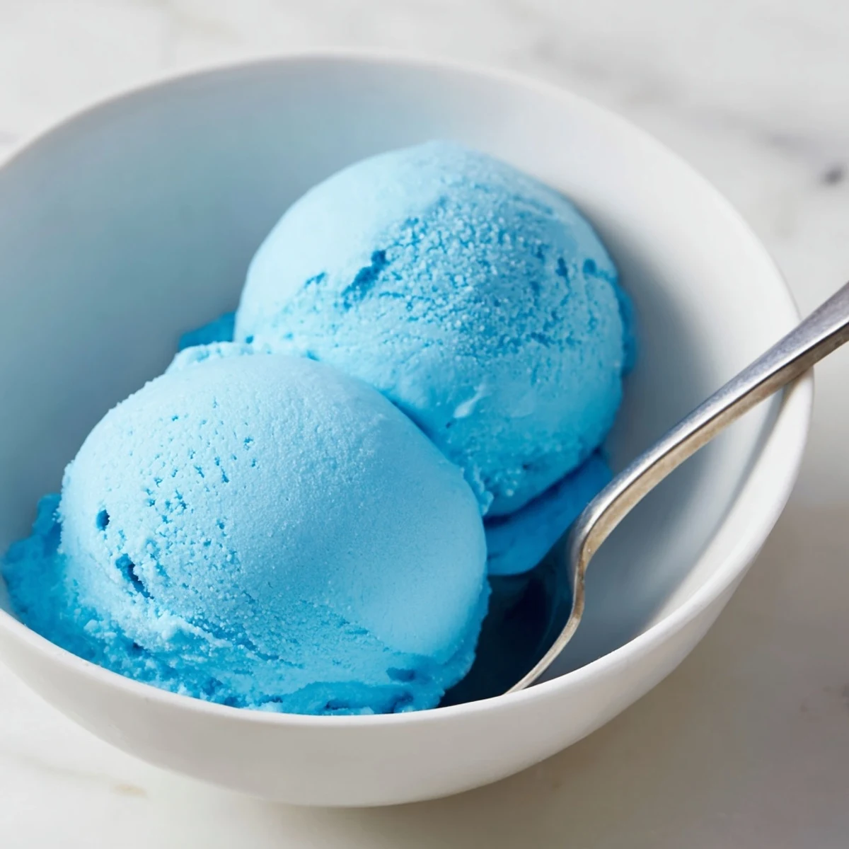 Bright blue moon ice cream scooped into a crispy waffle cone