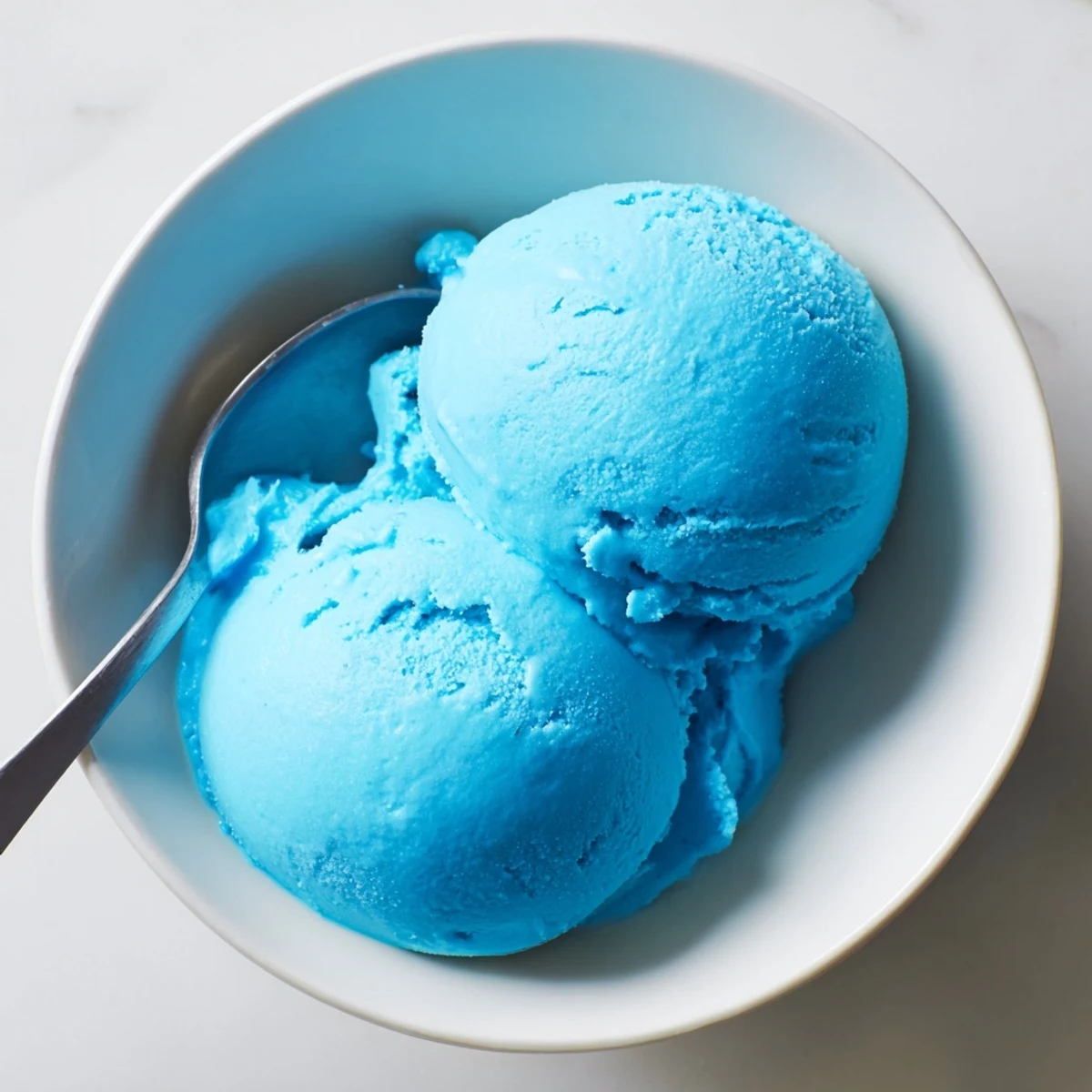 Creamy blue moon ice cream swirling with vivid sky-blue colors