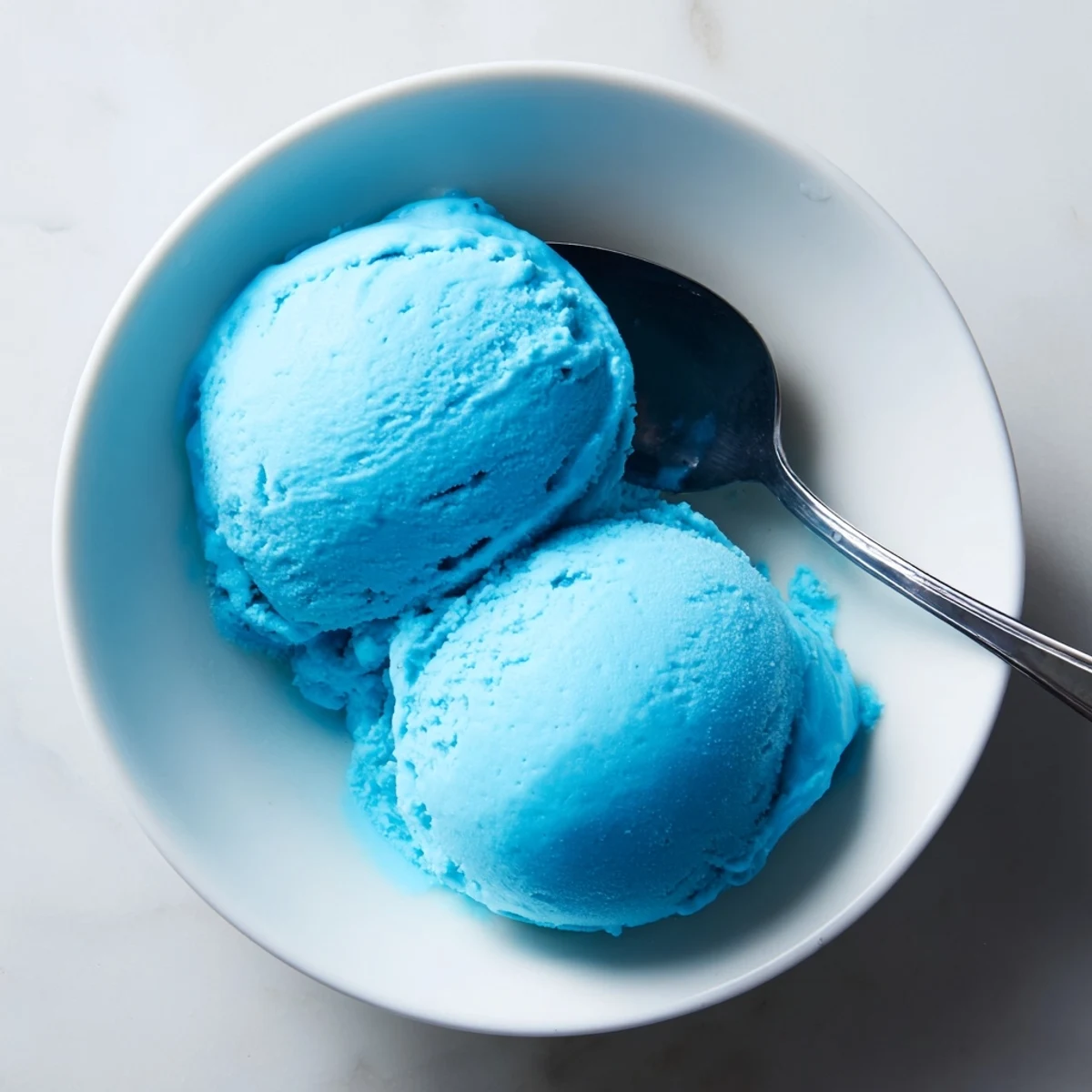 Smooth blue moon ice cream served in a chilled glass bowl