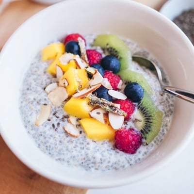Chilled Coconut Chia Pudding in glass jars, garnished with fresh berries